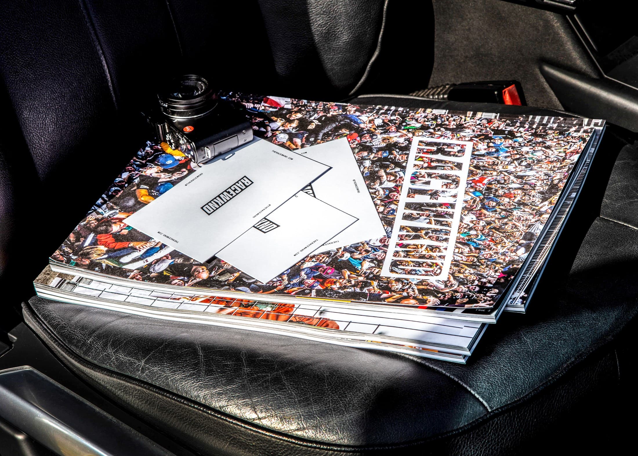 RACEWKND magazines and a Leica on a vintage car seat